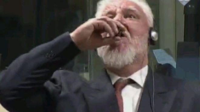 War crimes suspect takes poison in court