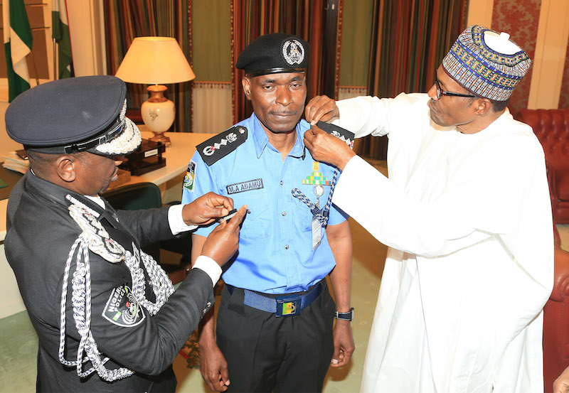 President Muhammadu Buhari decorates the new Inspector General of Police, Mr Mohammad Abubakar Adamu at the State House Abuja, on Tuesday, January 15, 2019.  PHOTO: SUNDAY AGHAEZE