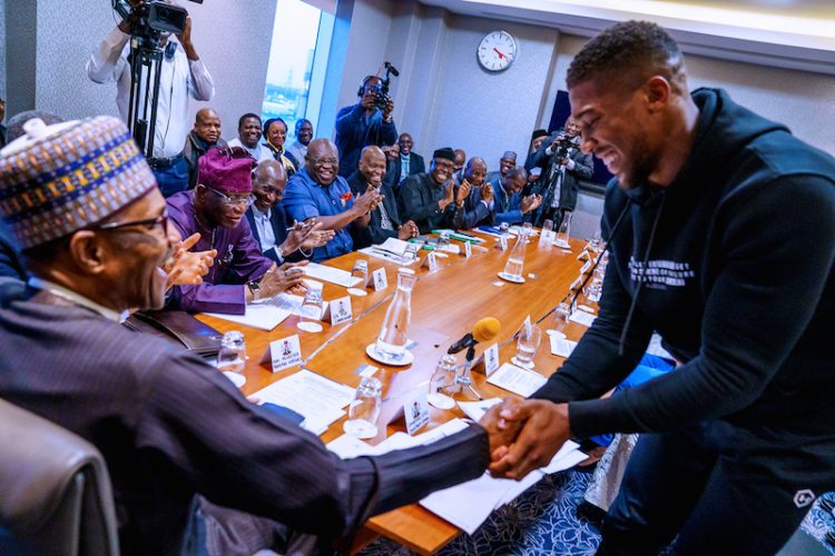 PHOTOS: Anthony Joshua presents belts to Buhari, prostrates