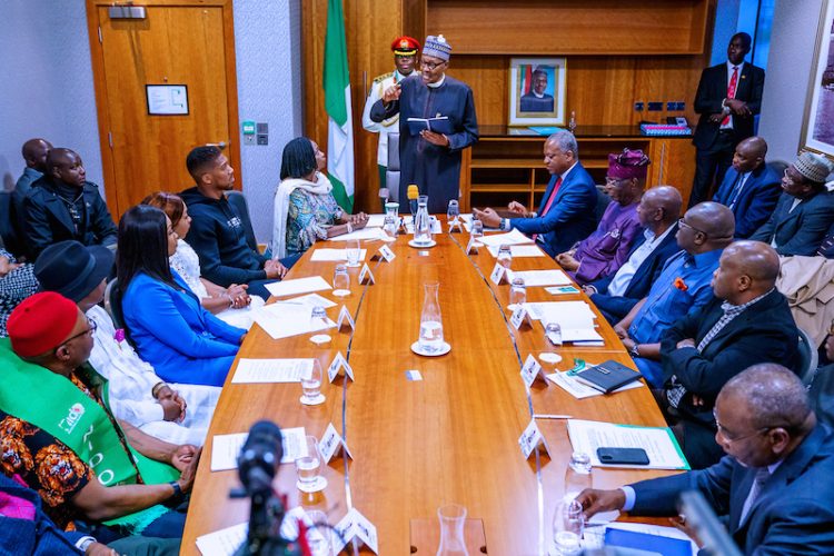 PHOTOS: Anthony Joshua presents belts to Buhari, prostrates