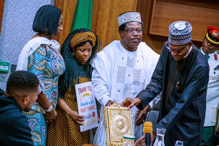 PHOTOS: Anthony Joshua presents belts to Buhari, prostrates