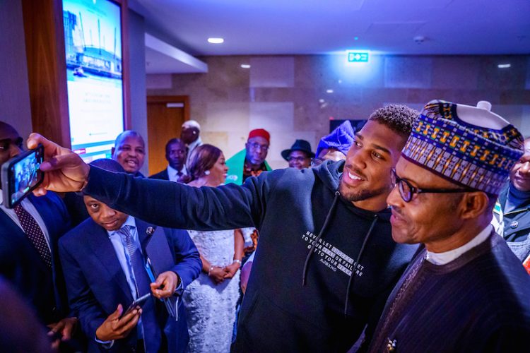 PHOTOS: Anthony Joshua presents belts to Buhari, prostrates